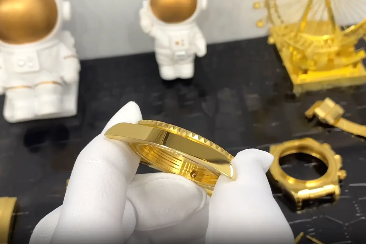 Close-up inspection of watch movement and components during assembly process
